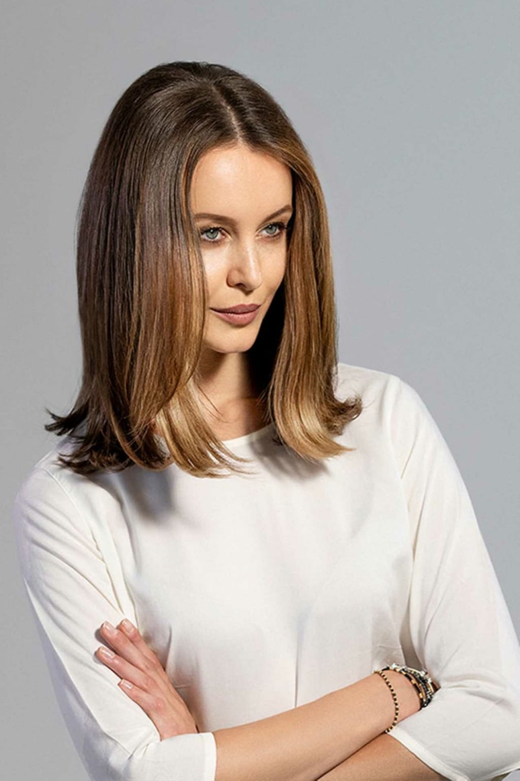 After hair thickening in lengths and tips in a woman with brown hair