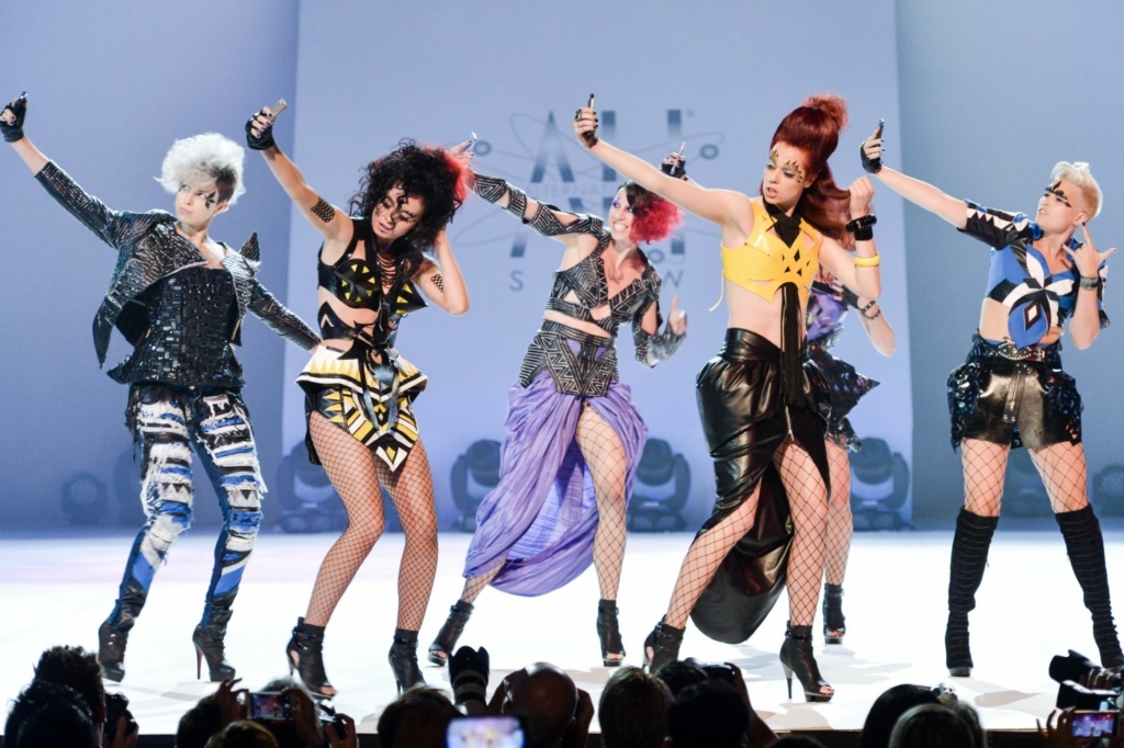 Models perform on stage with their fancy Hairdreams hairstyles.