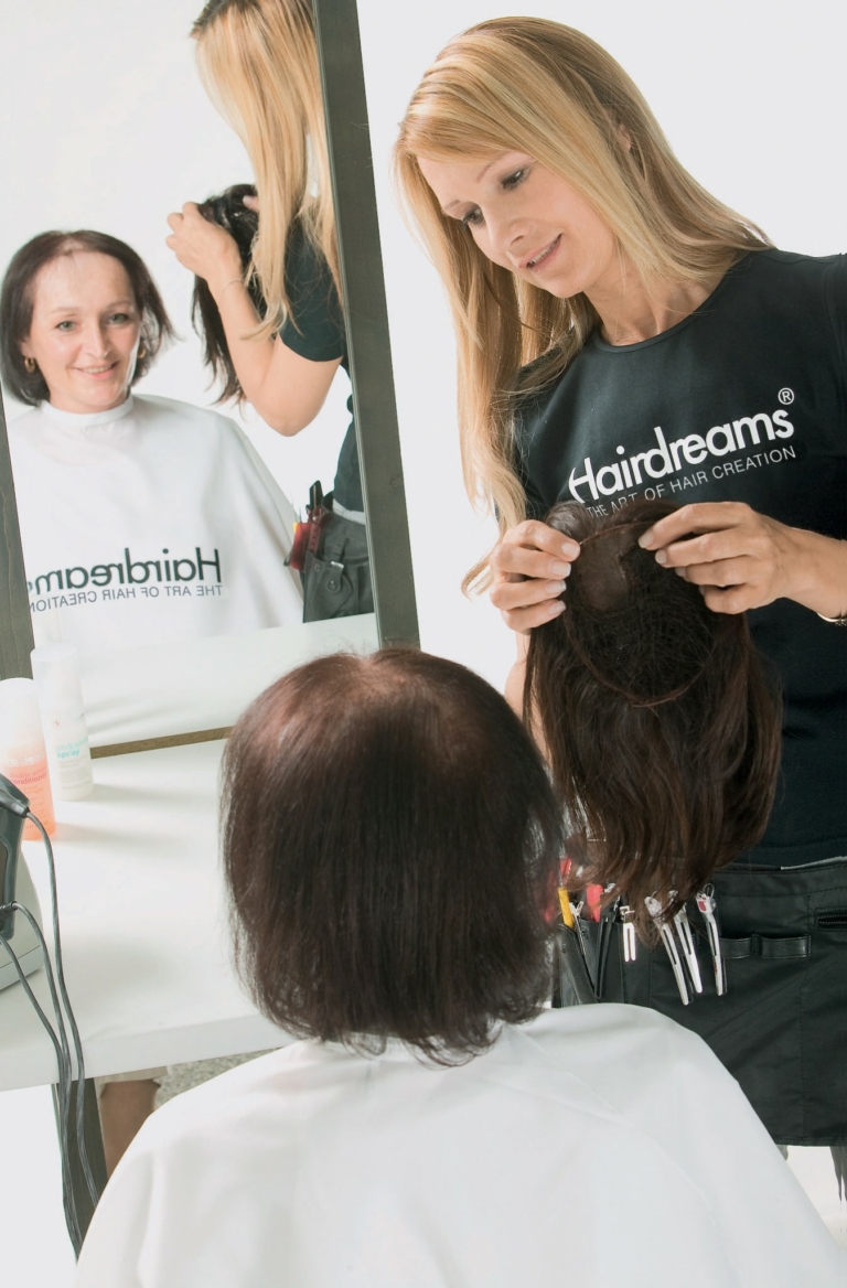 A Hairdreams hairdresser advises a customer on the MicroLines system.