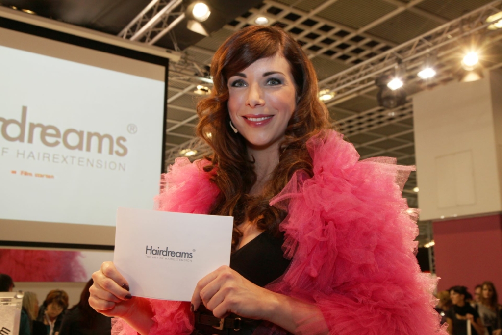 Presenter Alexandra Polzin with her Hairdreams hair at the hairdressing fair in Paris.